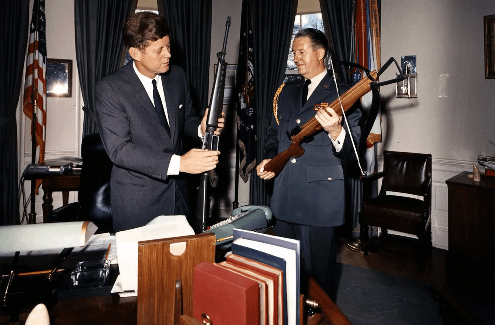 John F. Kennedy and major general Clifton in the Oval Office, examining an AR-15 and a CIA-developped crossbow, 1963 (1600×1052)