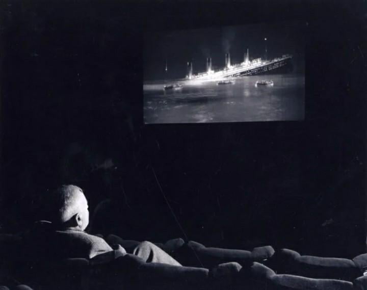 Commander Joseph Groves Boxhall watching the Titanic film “A Night To Remember” (1958), he was also the actual 4th officer on the Titanic when it sank in 1912.   (720×569)