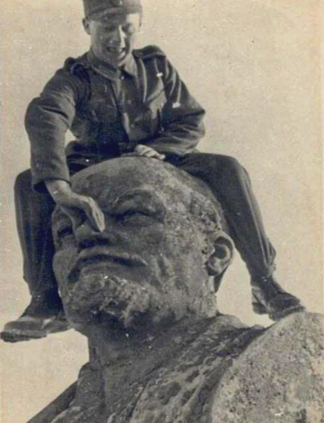 German soldier mocking a Lenin statue, 1942. [1080×1409]