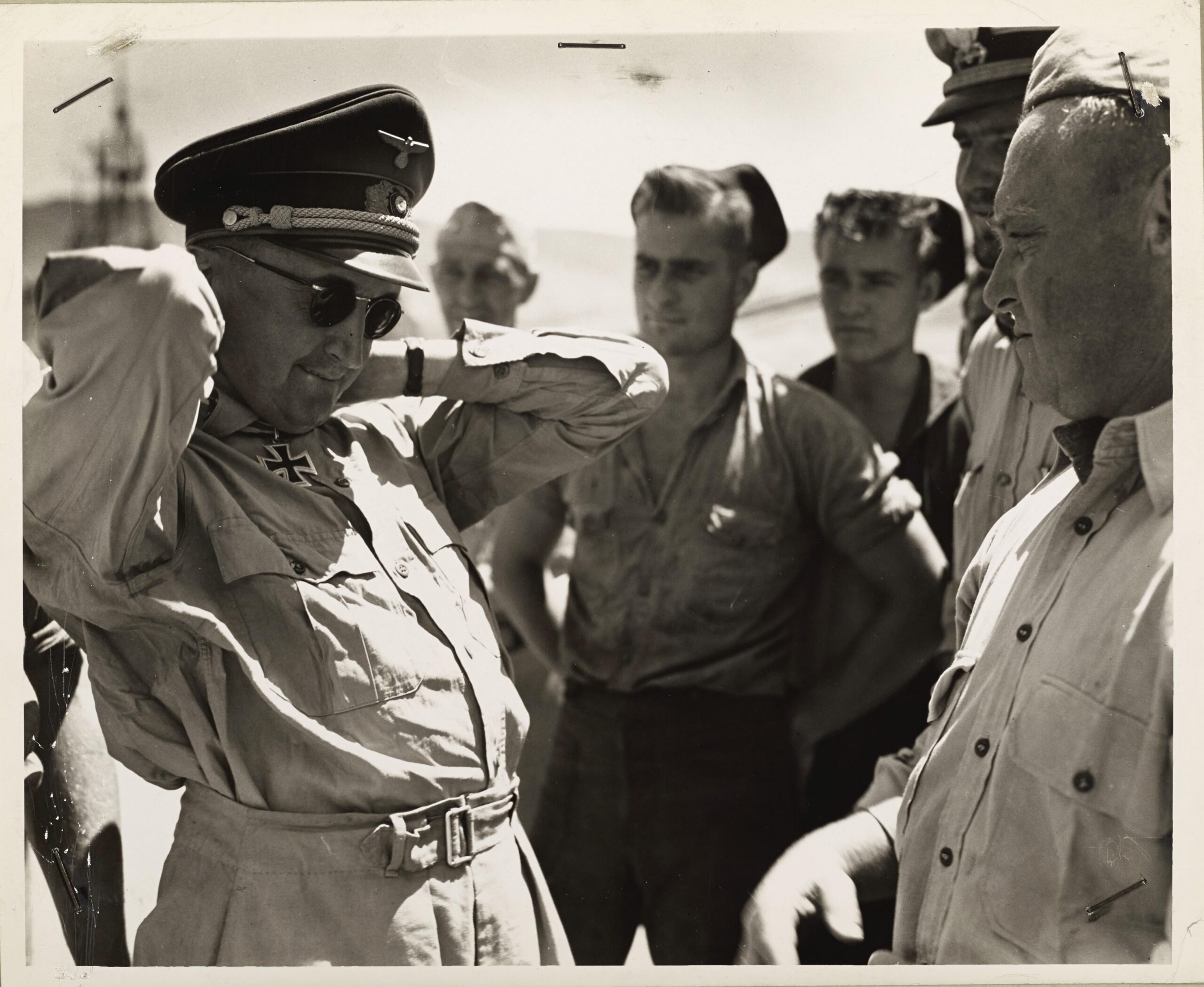 A German officer hands over his Iron Cross to a U.S. Coast Guardsman while being transported from North Africa, 1943 [4562×3741]
