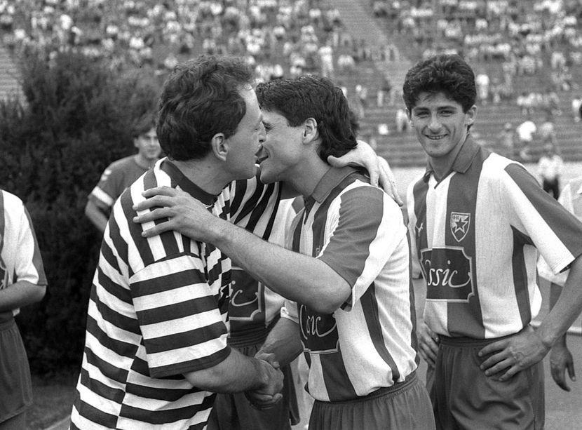 Serbian warlord Željko Ražnatović “Arkan” kisses a member of the Red Star Belgrade soccer team, Serbia, 1991. [830×613]