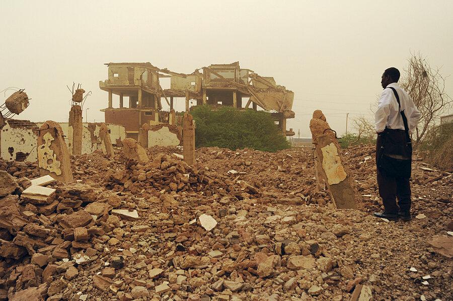 A Sudanese stand before the ruins of the Al-Shifa pharmaceutical factory which was supplying around 50% of the country medicines. Destoryed by the US in 1998[900×598].