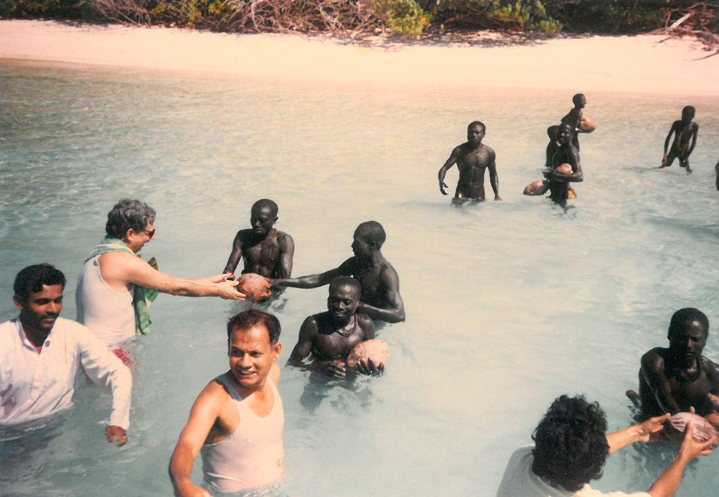 Indian anthropologists pass coconuts to the Sentinelese, North Sentinel Island 1991.[1464×1013]