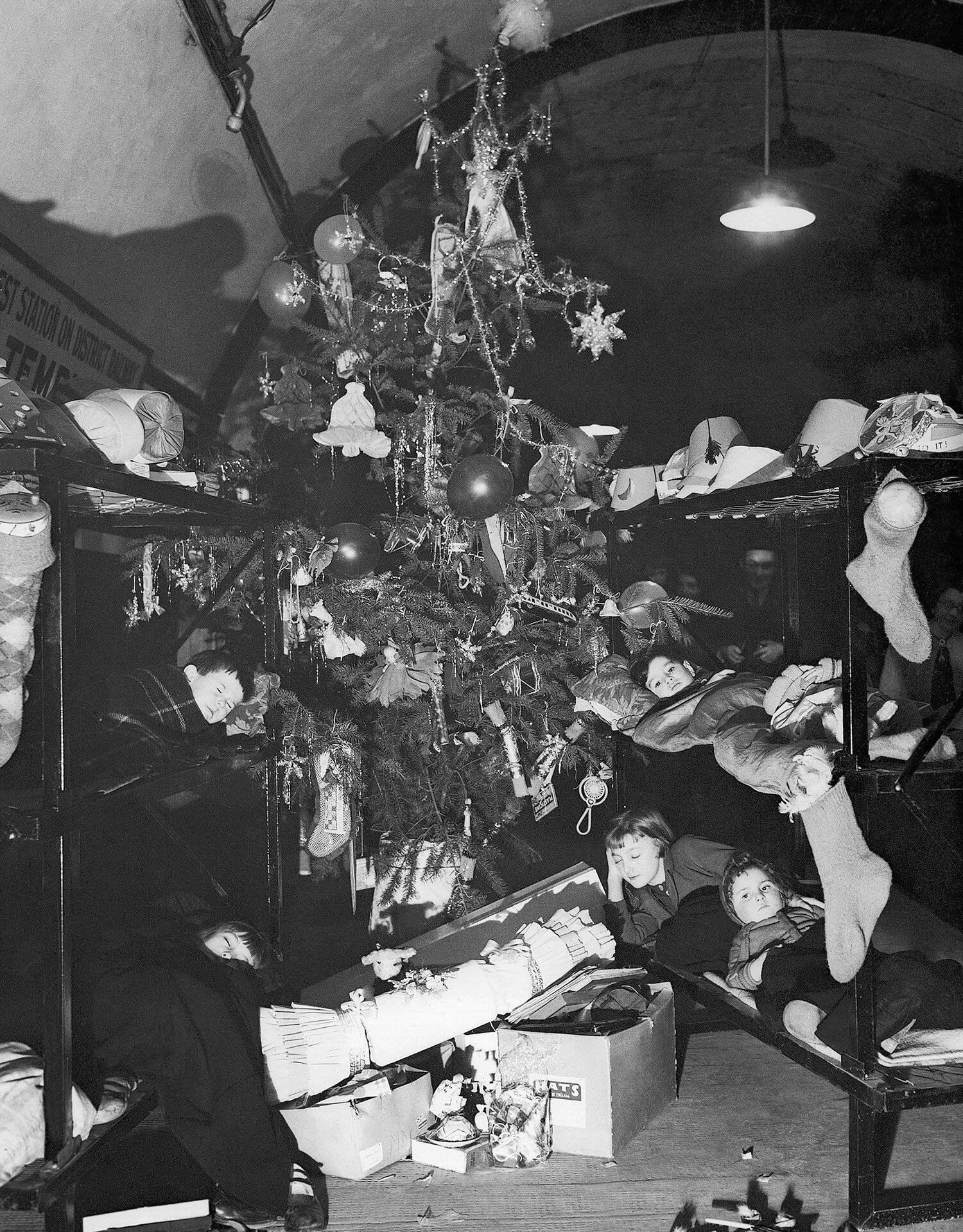 Children sheltering in Temple Tube Station on Christmas Day during The Blitz. (1940) [1500×1919]