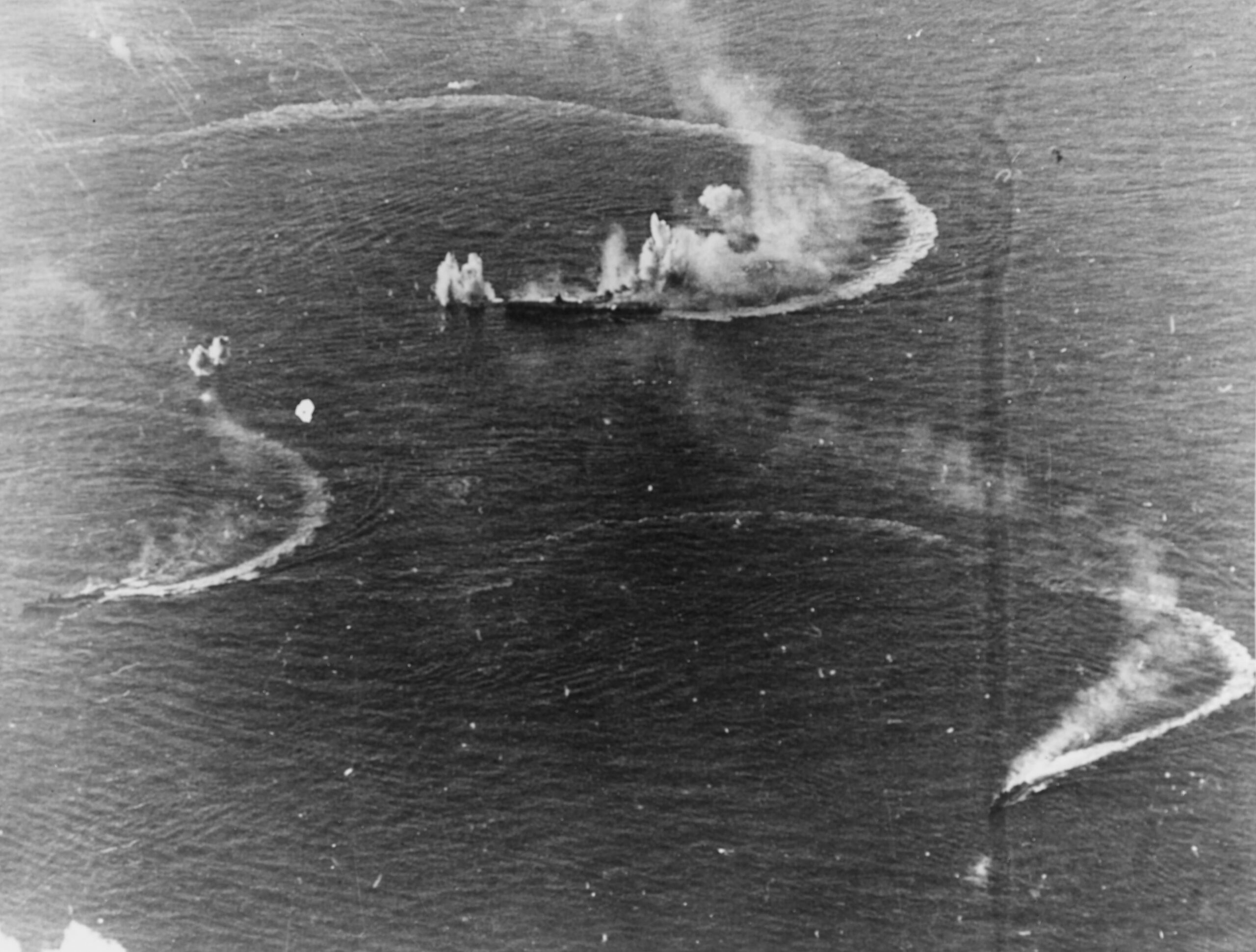 Battle of the Philippine Sea: the Japanese aircraft carrier Zuikaku (center) and the destroyers Akizuki and Wakatsuki maneuvering, while under attack by U.S. Navy carrier aircraft, 20 June 1944. Zuikaku was hit by several bombs during these attacks, but survived [5694 × 4318]