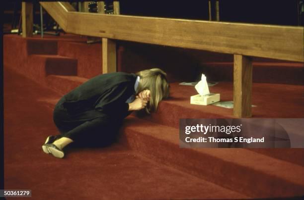 February 1st, 1988: A lone parishoner overcome with grief lying on steps to the altar sobbing in her arms after TV evangelist Rev. Jimmy Swaggart’s confession of sexual indiscretions during a sermon. (612×404)