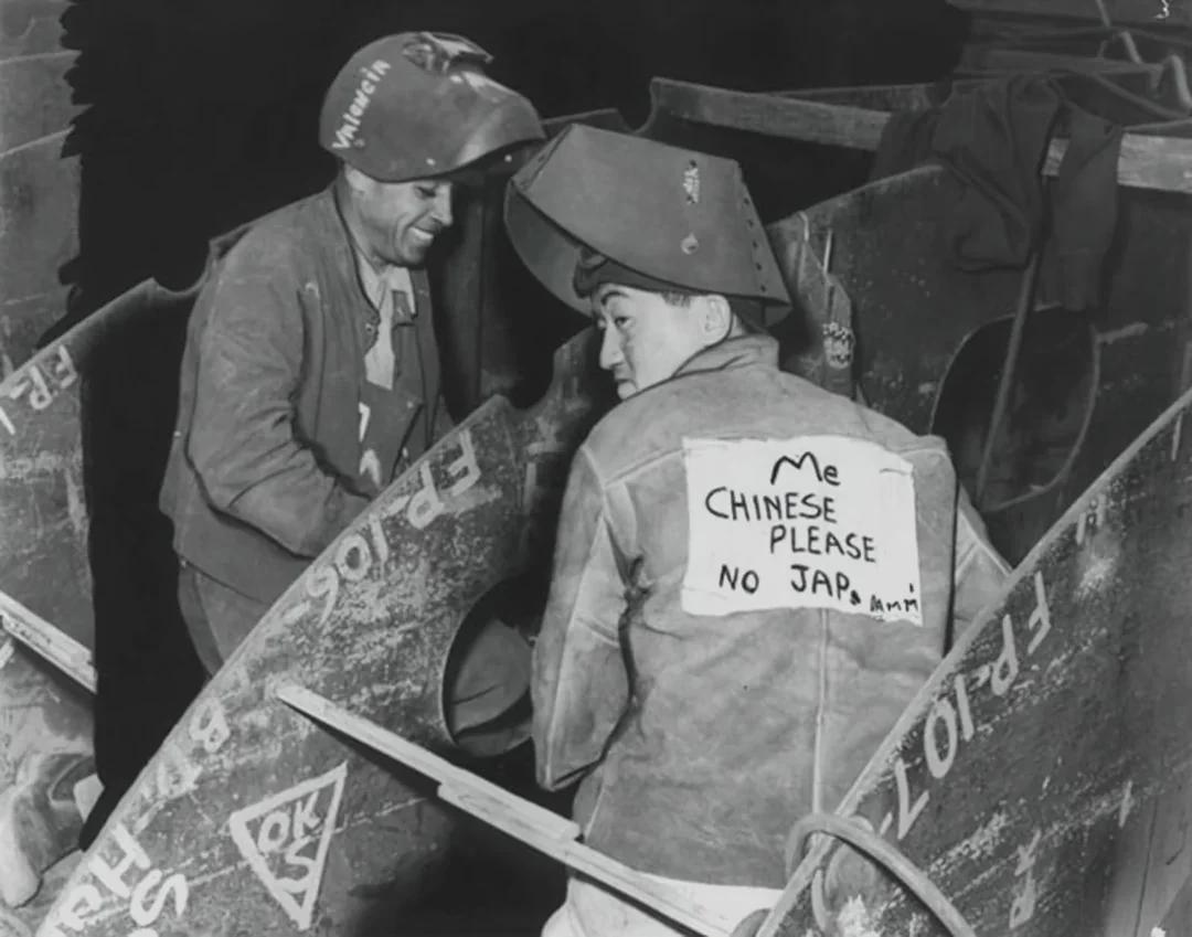 A Chinese American man wearing a sign stating he is Chinese, not Japanese, to avoid harassment at work, 1940s. [1080×849]