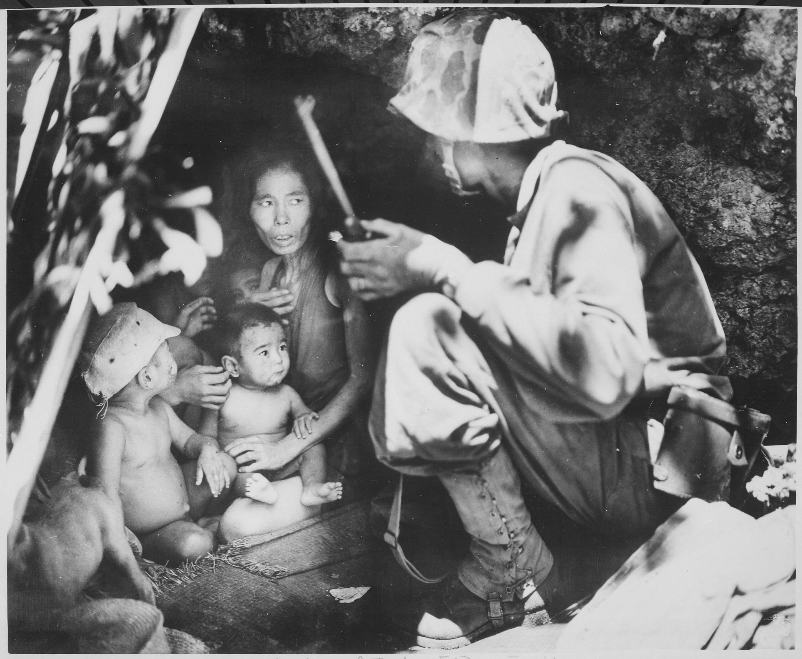 U.S. Marine First Lieutenant Robert B. Sheeks, a combat intelligence and Japanese language officer with the 2nd Marine Division, convinces a Japanese family to surrender. Saipan, 21 June 1944 [3000 × 2465]
