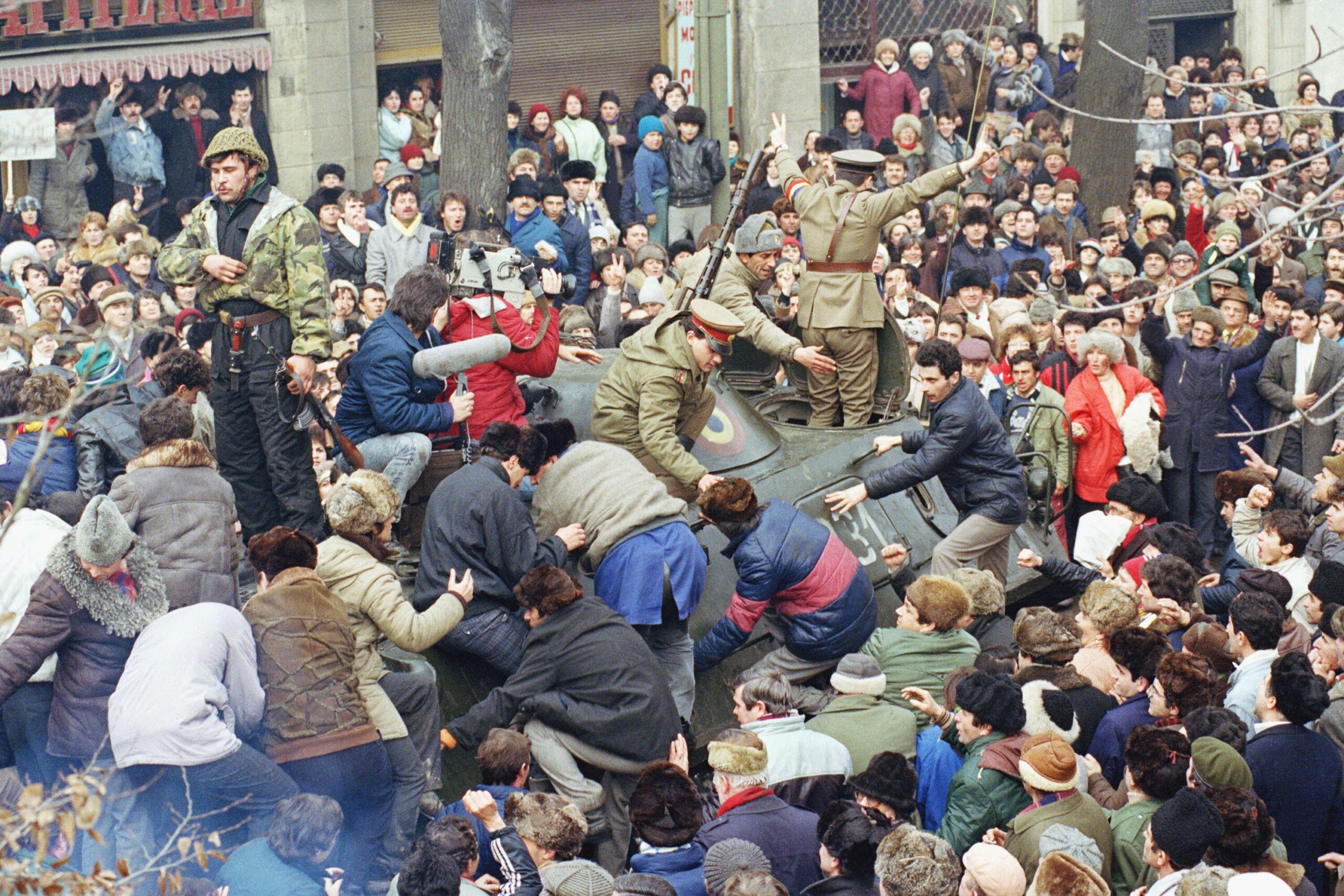 Supporters of the National Salvation Front – the interim post-revolutionary Romanian government, criticised by opponents for retaining the former communist leadership & power structure, storming an armoured vehicle carrying the anti-establishment National Peasants Party leader. (1990) [3000×1999]