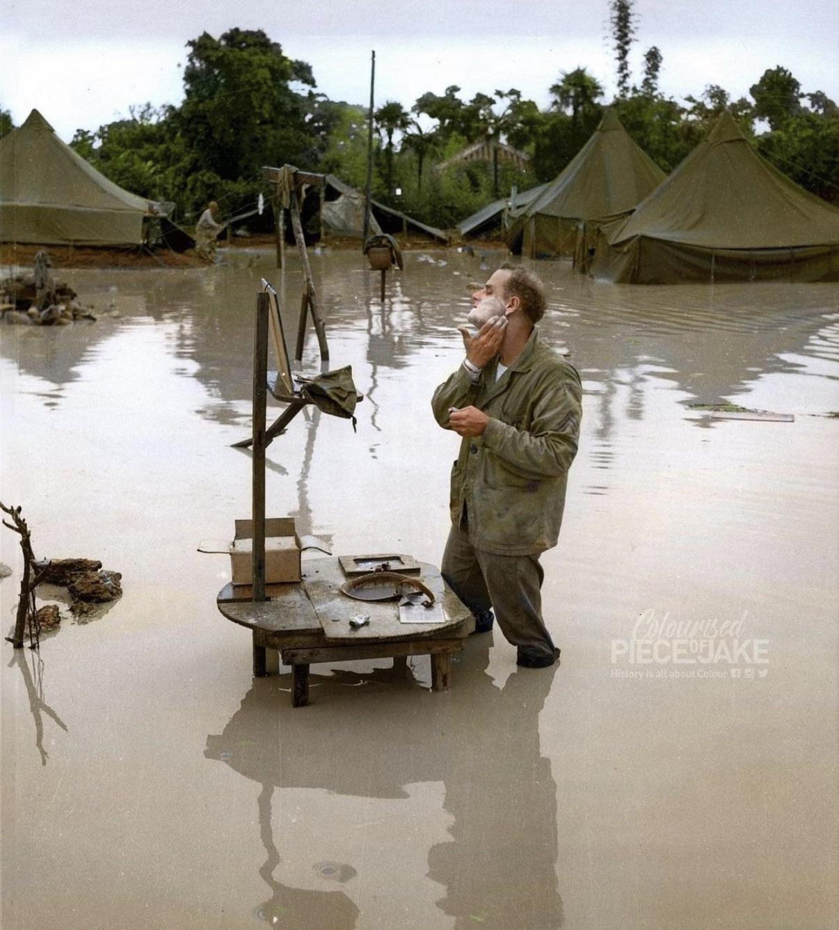 Marine Staff Sergeant A. S. Barnacle shaving at a washstand that is half-submerged, 05-28-1945 (820×1220)