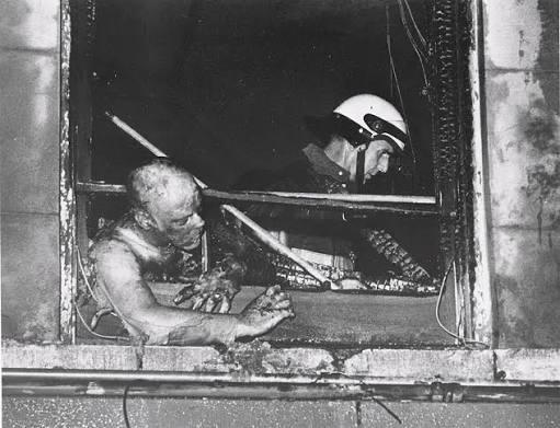 On 6-24, 1973, an arsonist set fire to the Upstairs Lounge, a popular gay bar and home to the Metropolitan Community Church in NO French Quarter. Pictured here is the trapped Rev. Bill Larson, an openly gay pastor who led the congregation and provided a safe sanctuary to worship. [512×385]