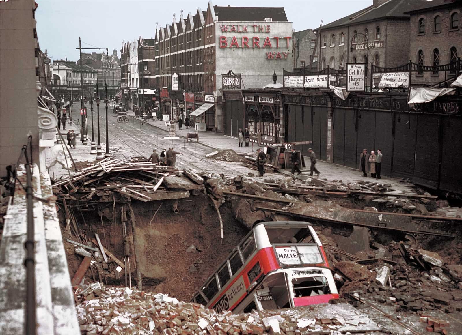 Double-decker bus in a bomb crater above Balham underground station, South London, in October 1940, during the Blitz of World War ll. The bus had been travelling at night in black-out conditions when it drove into the crater. No one aboard the bus was killed. Colourised. [1600×1161]