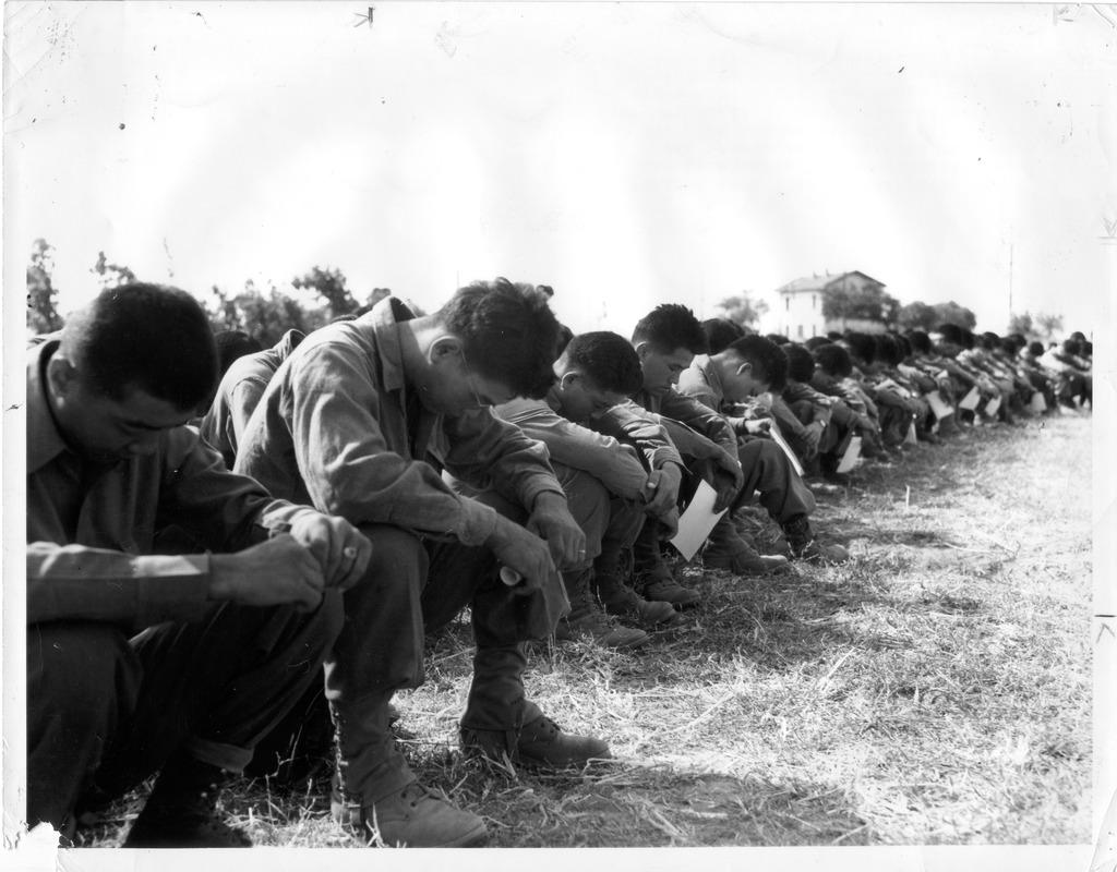 Japanese-American soldiers of the 2nd Battalion, 442nd Infantry Regiment, bow their heads in prayer for their departed comrades who gave their lives in combat, Battalion Headquarters area near Cecina, Italy, 1944. [1024 × 800]