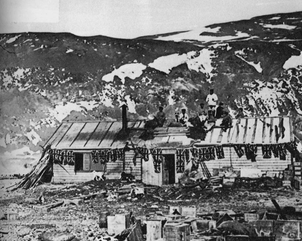Members of Carsten Borchgrevink’s 1899 expedition team stand on top of the first human structure ever built in Antarctica. Borchgrevink’s team built two huts at Cape Adare in 1899, both of which remain standing today and were used by subsequent expedition teams as a base camp.  [1000 x 799]