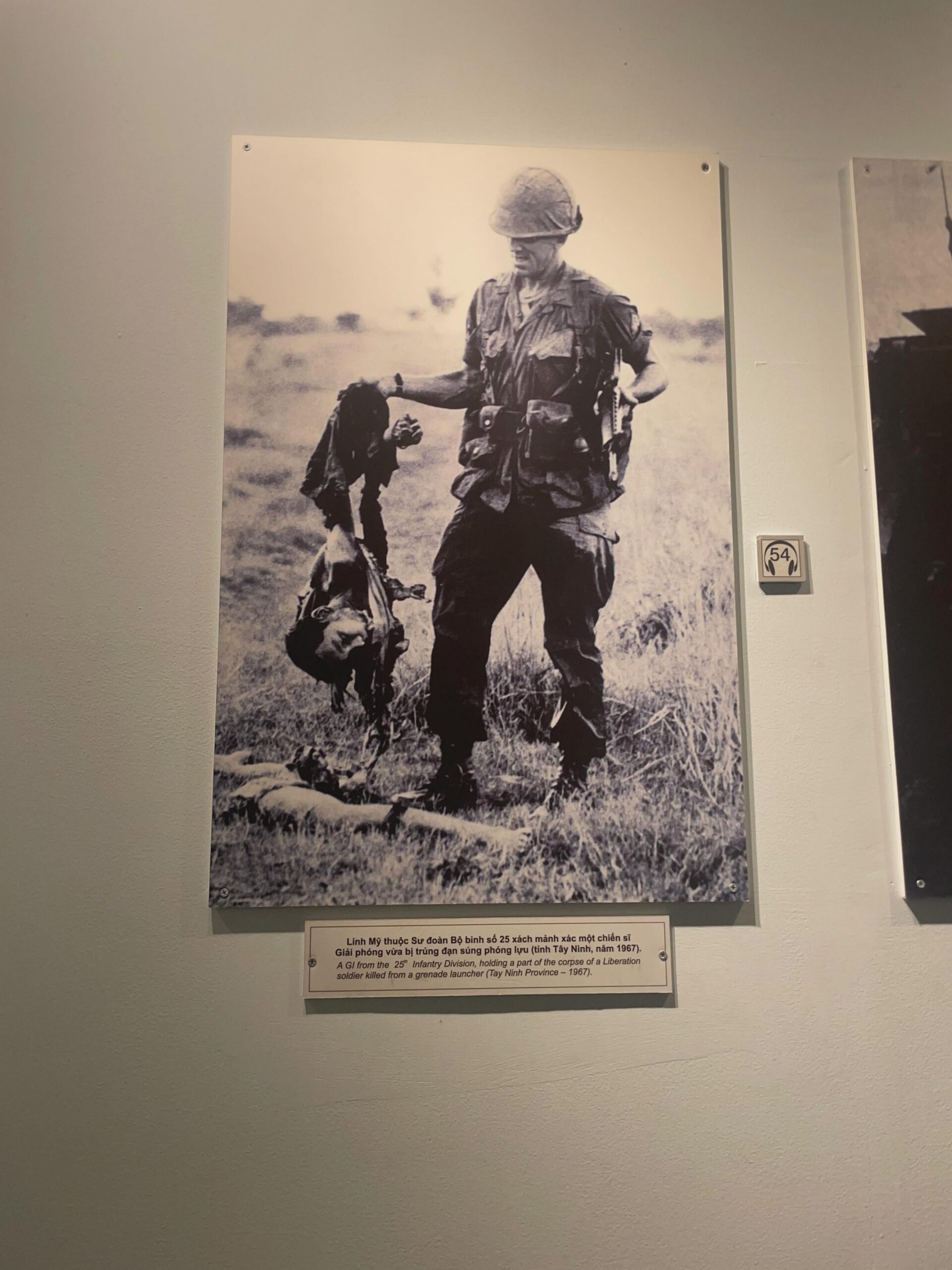 A GI from the 25th Infantry Division, holding a part of the corpse of a Liberation soldier killed from a grande launcher, 1967.[3024×4032]