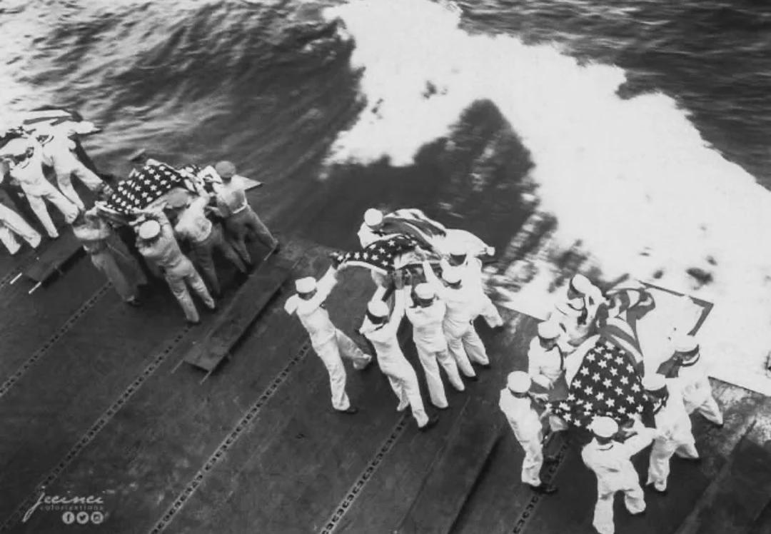 Burial at sea aboard USS Hancock for those killed by a Japanese attack two days prior. Off Okinawa, Japan, 9 April 1945. [1080×748]