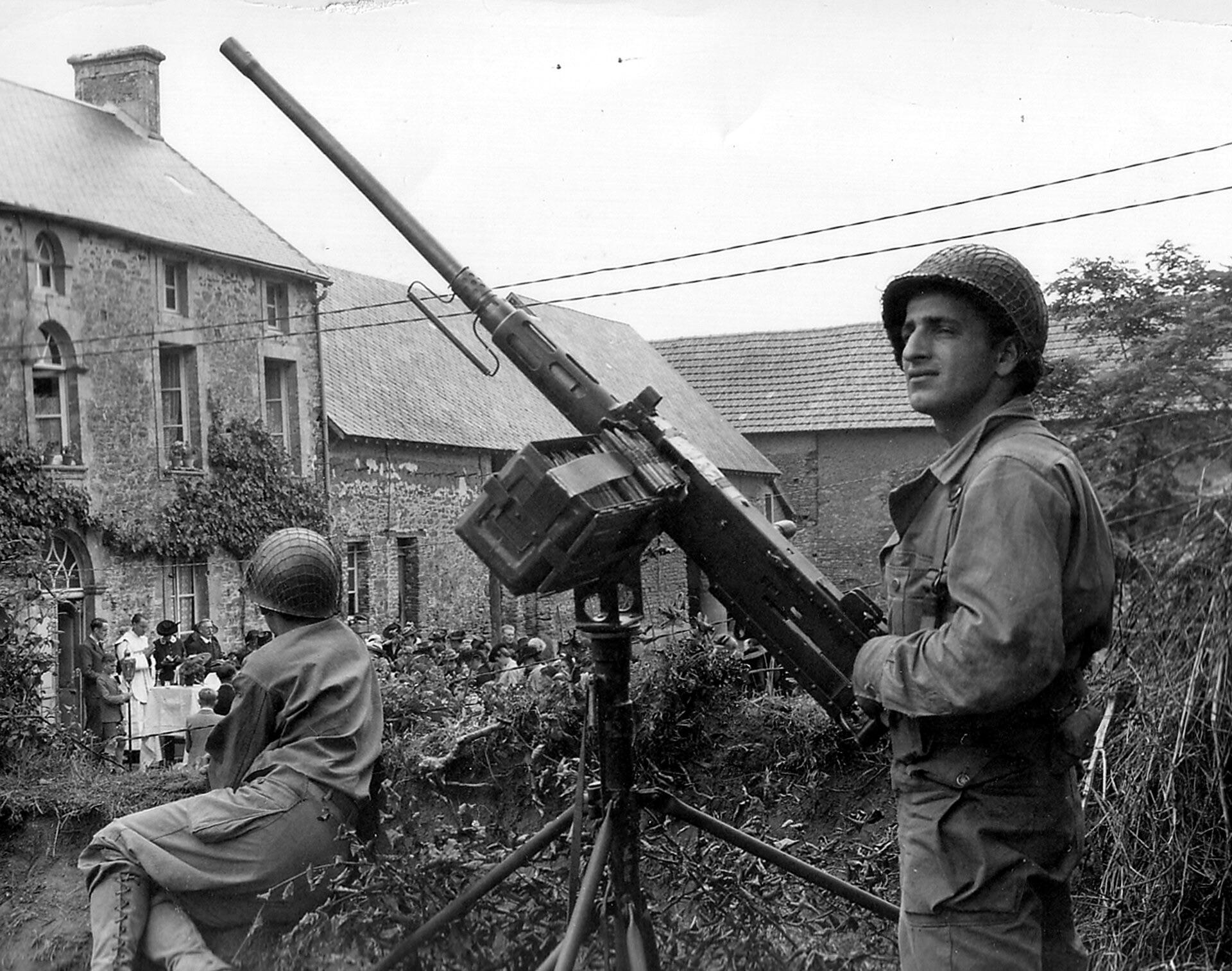 During the liberation of Lower Normandy during the summer of 1944, in the American sector. A local assembly solemnly gathered in the courtyard of a farm, under the watchful eyes of two GIs. [1920×1513]
