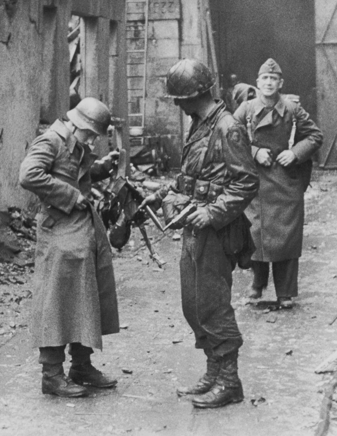 An American soldier disarms a German prisoner of war after the Battle of Cherbourg, France, June 1944. [1080×1396]