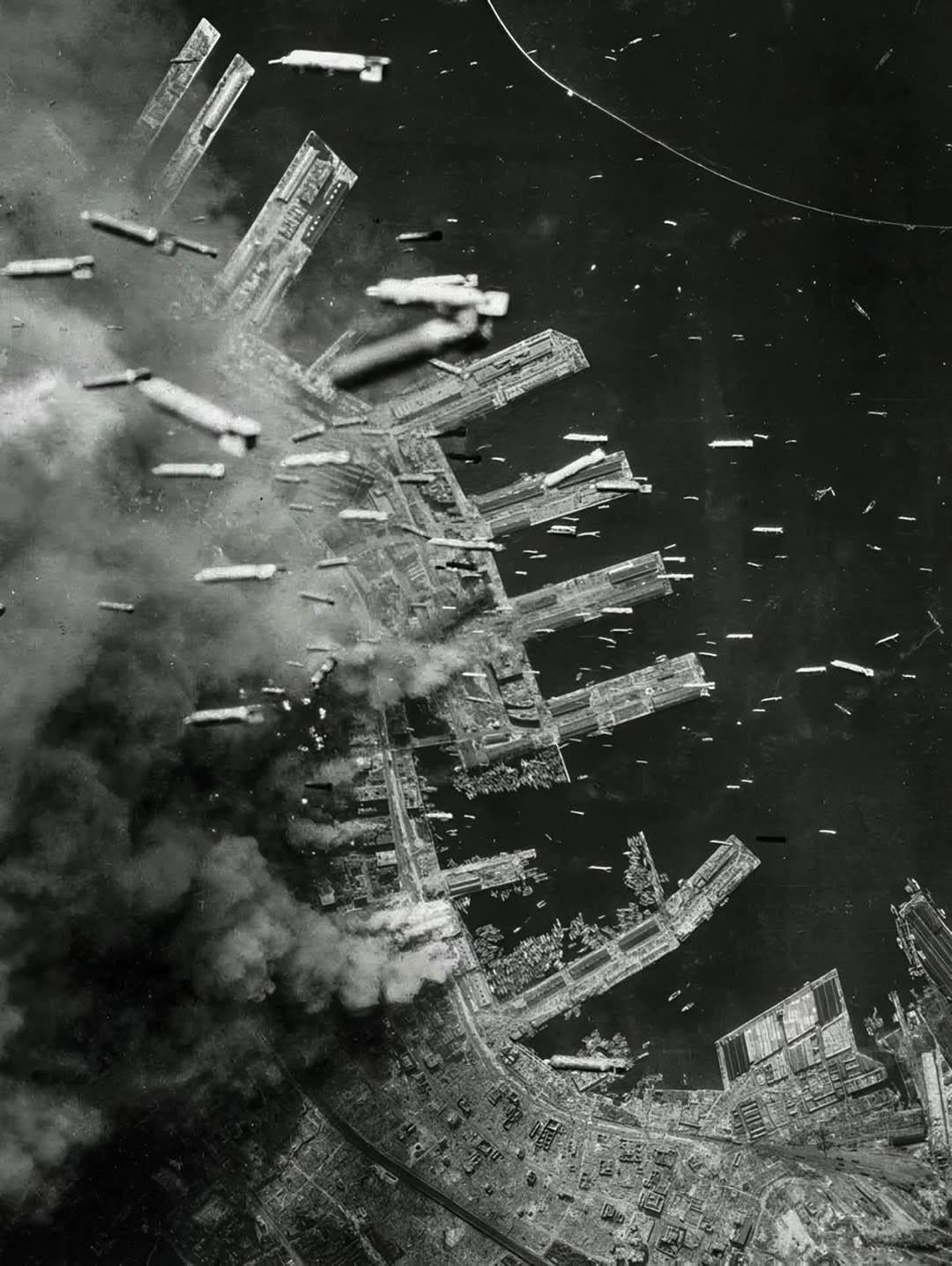 Incendiary bombs are dropped from USAAF Boeing B-29 Superfortress heavy bombers – over the port city of Kobe, Japan, c. June 4th, 1945. [1080 x 1436]
