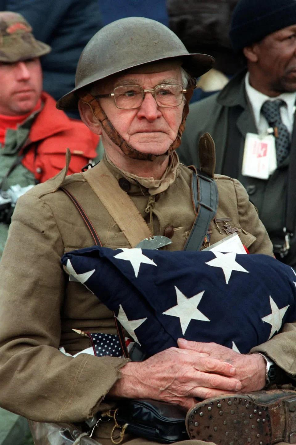 Joseph Ambrose, an 86 year old World War I veteran, attends the dedication day parade for the Vietnam Veterans Memorial in 1982. Wearing his WWI uniform, he is holding the flag that covered the casket of his son Clement, who was killed in the Korean War. [1363×2048]