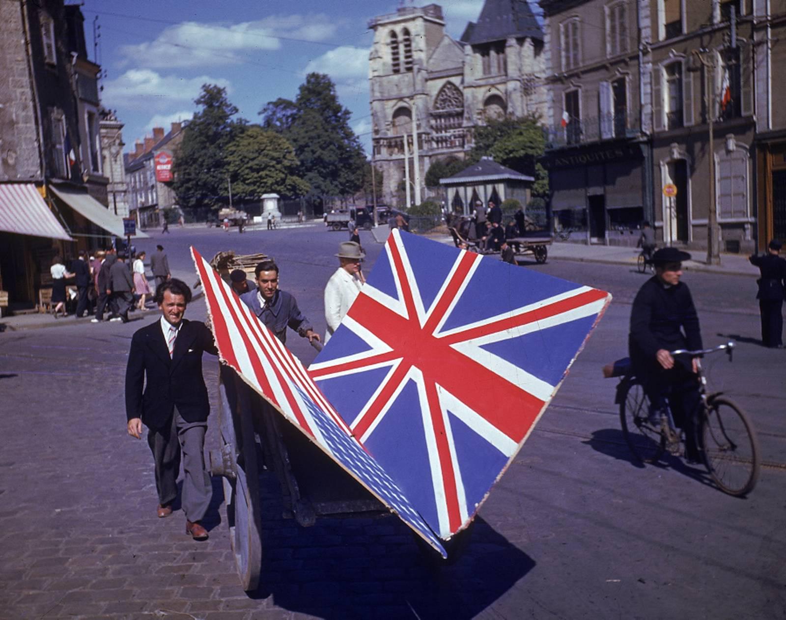 Frenchmen transporting British and American flags in celebration of the Liberation of Paris. (1944) [1600×1262]