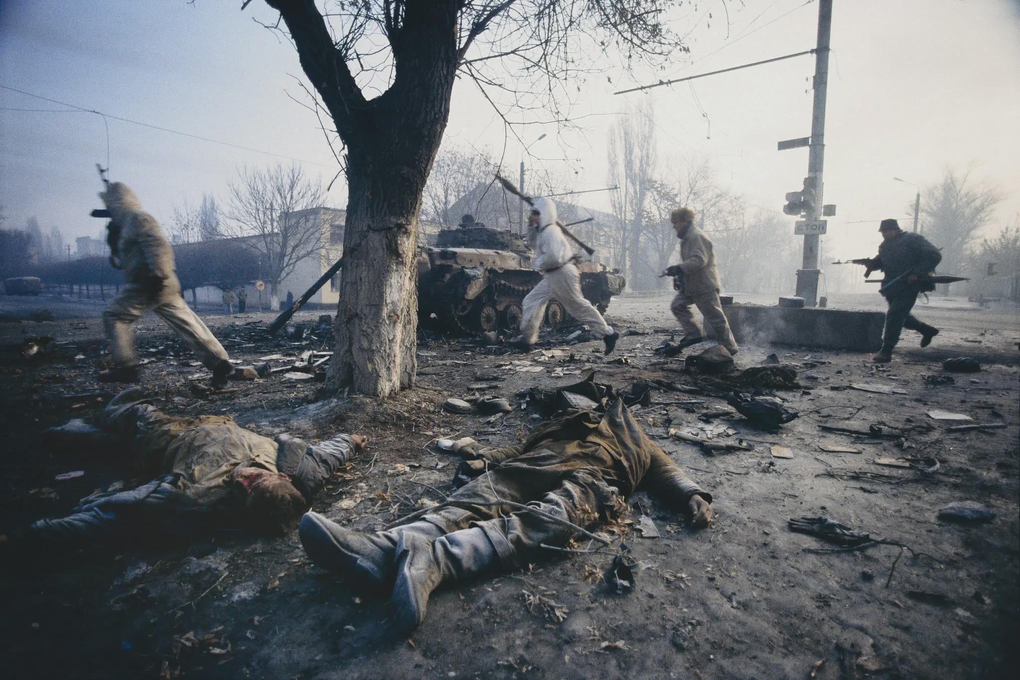 Grozny, Chechnya.  1995.  Chechen separatist insurgents running past the corpses of Russian soldiers during the early days of the First Chechen War.  [2048 x 1366]