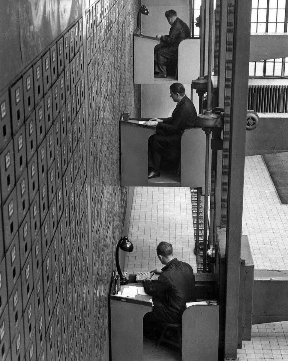 File clerks working at their electric elevator desks in Prague, former Czechoslovakia, 1937. [960 x 1200]