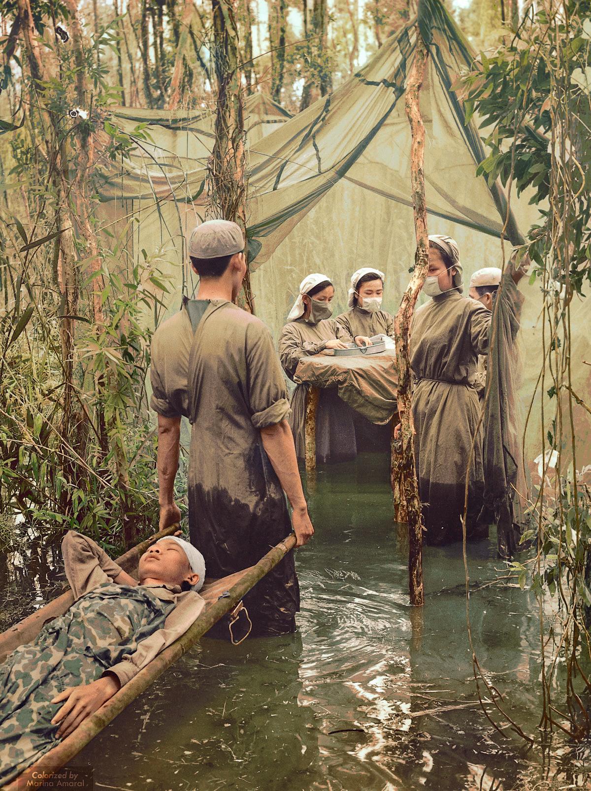 A makeshift field hospital during the Vietnam War set in a mangrove swamp on the Ca Mau Peninsula, located in the southern part of Vietnam. Colourised. (1970) [1200×1606]