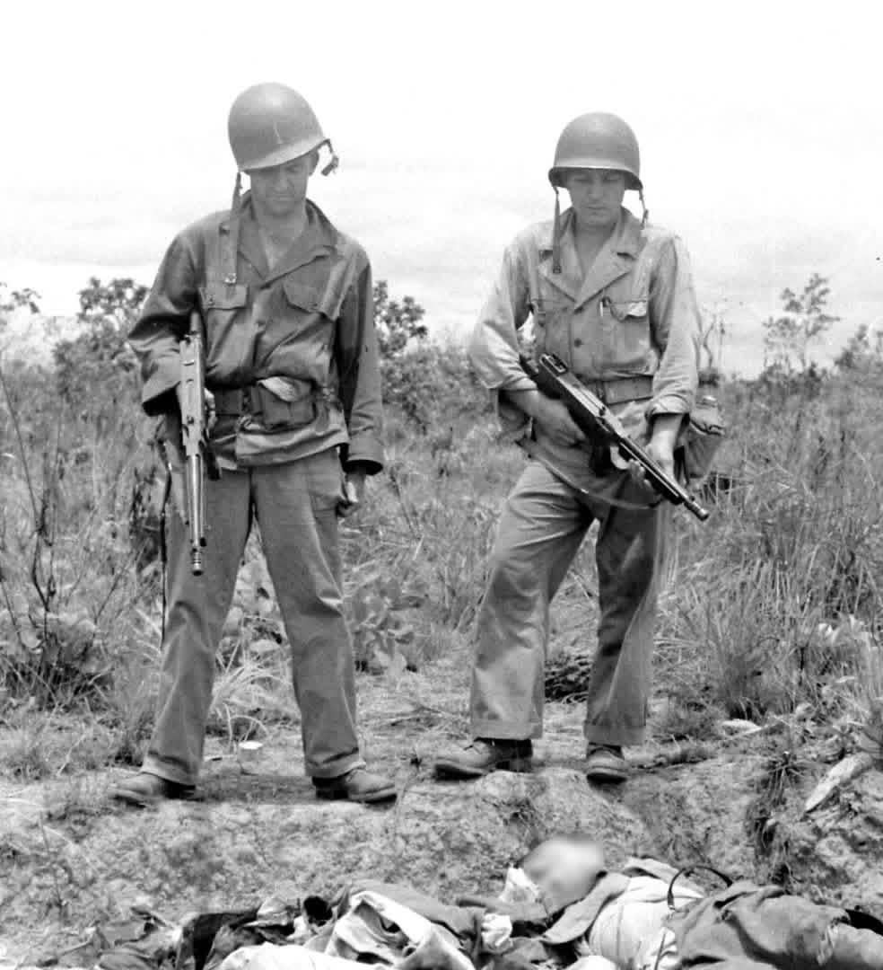 Two members of “Merrill’s Marauders”, both armed with M1928A1 Thompson SMGs look at two fallen Japanese soldiers at Myitkyina Airfield in Burma – May 1944 [984×1080]