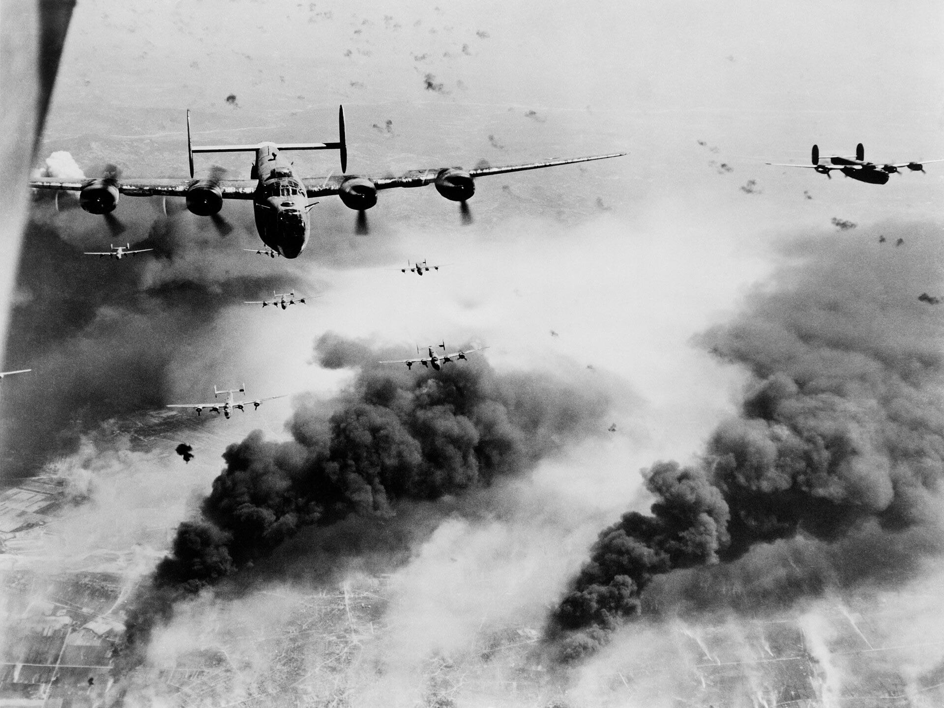 Waves of Consolidated B-24 Liberators of the 15th AAF fly over the target area, the Concordia Vega Oil refinery, Ploești, Romania, unmindful of bursting flak, after dropping their bomb loads on the oil plant, August 1, 1943. [1920×1441]