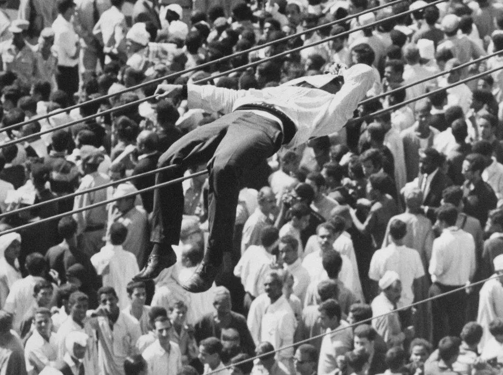 A mourner attemps to rest during the funeral of Gamal Abdel Nasser, Cairo, Egypt, 1970. [1024×764]