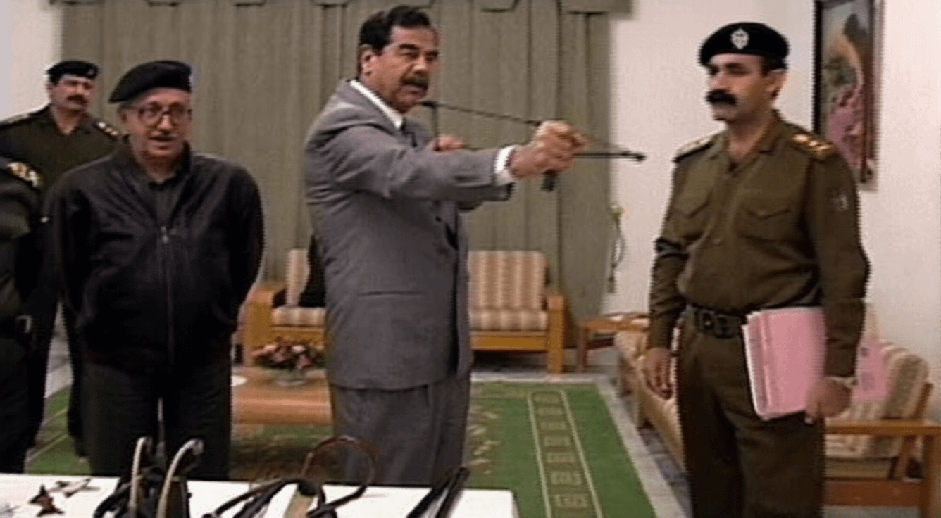 Saddam Hussein examining a slingshot in preparation for the US invasion in 2003 [1336×736]