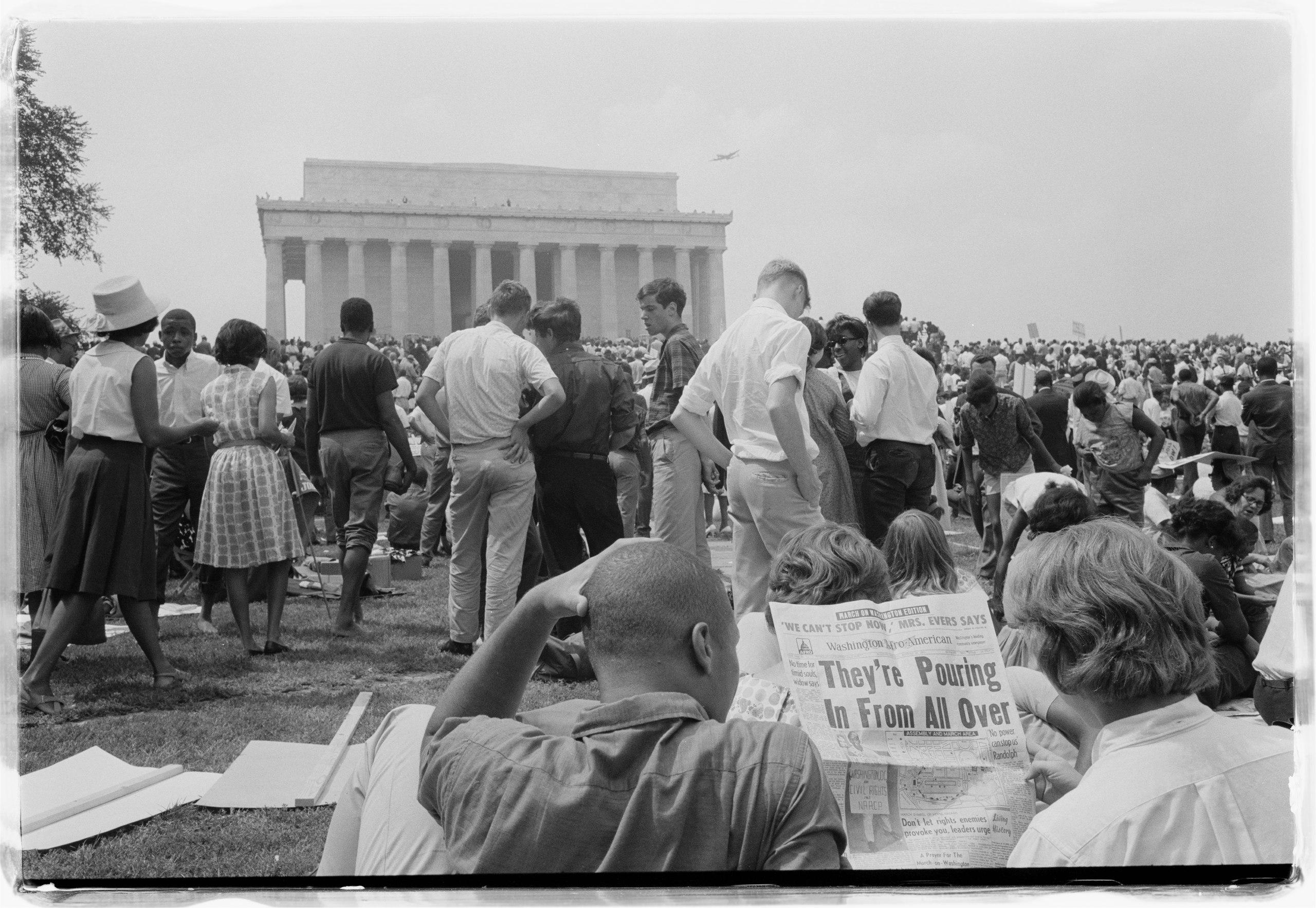 Protesters reading a pamphlet on the March on Washington in the Washington Afro American newspaper. (1963) [2560×1766]