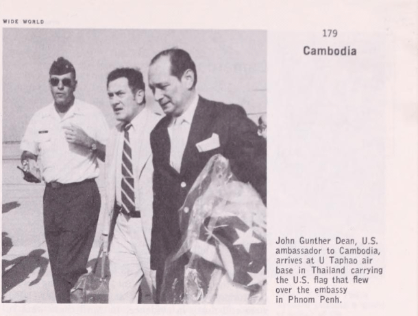 U.S. Ambassador John Gunther Dean walks off the plane in Thailand carrying the American flag from the embassy in Phnom Penh, April 11, 1975 [1975]