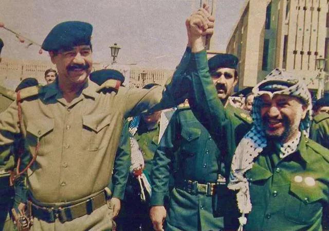 Palestinian Leader Yasser Arafat celebrates with Saddam Hussein following the Iraqi occupation of Kuwait, August 1990. [640×449]