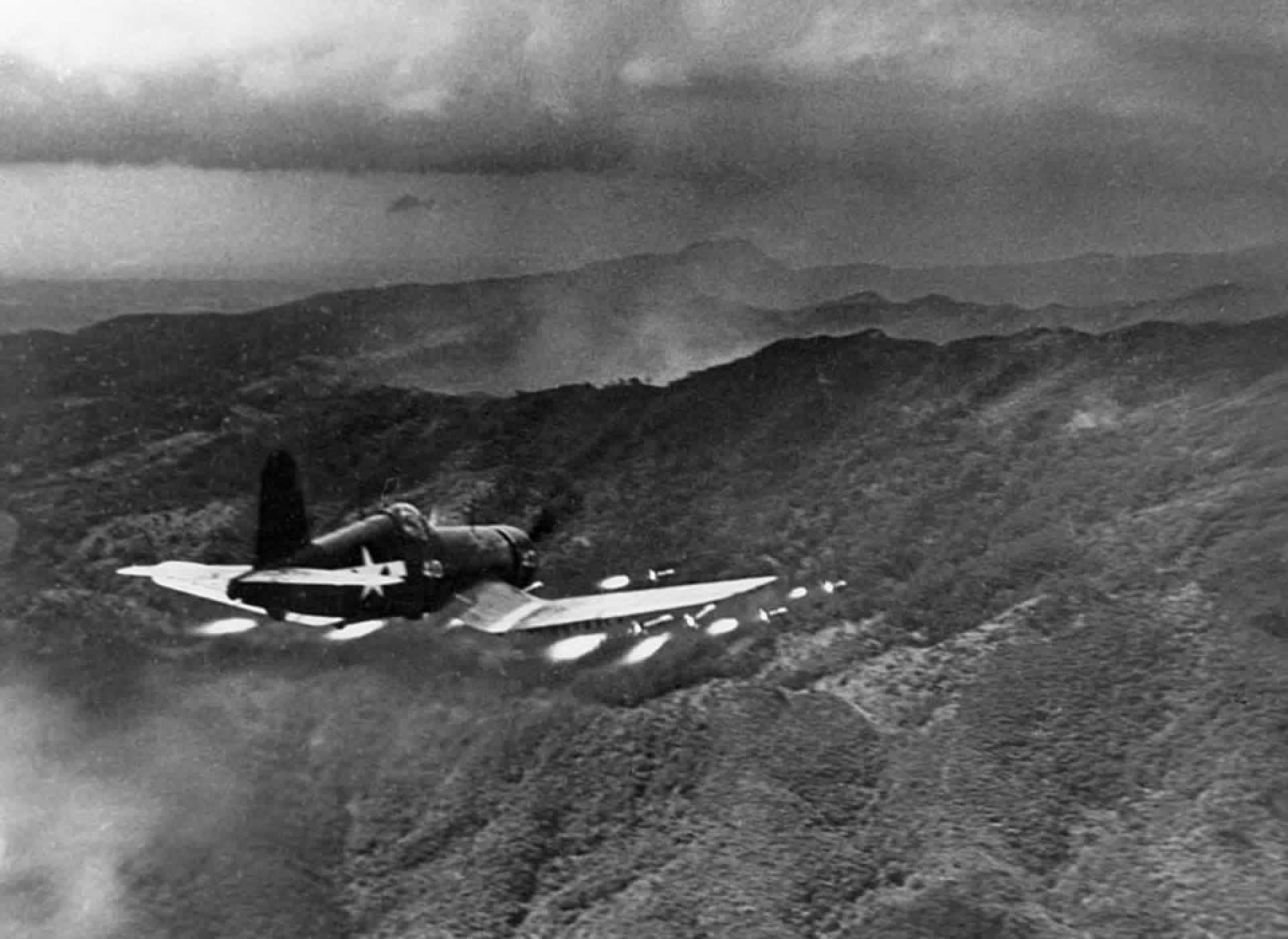 USMC Vought F4U Corsair fires a salvo of 5 inch rockets at a Japanese position in southern Okinawa, June 1945. Photographed from the observer pod of a P-38 Lightning by Lt David Douglas Duncan. [1920×1400]