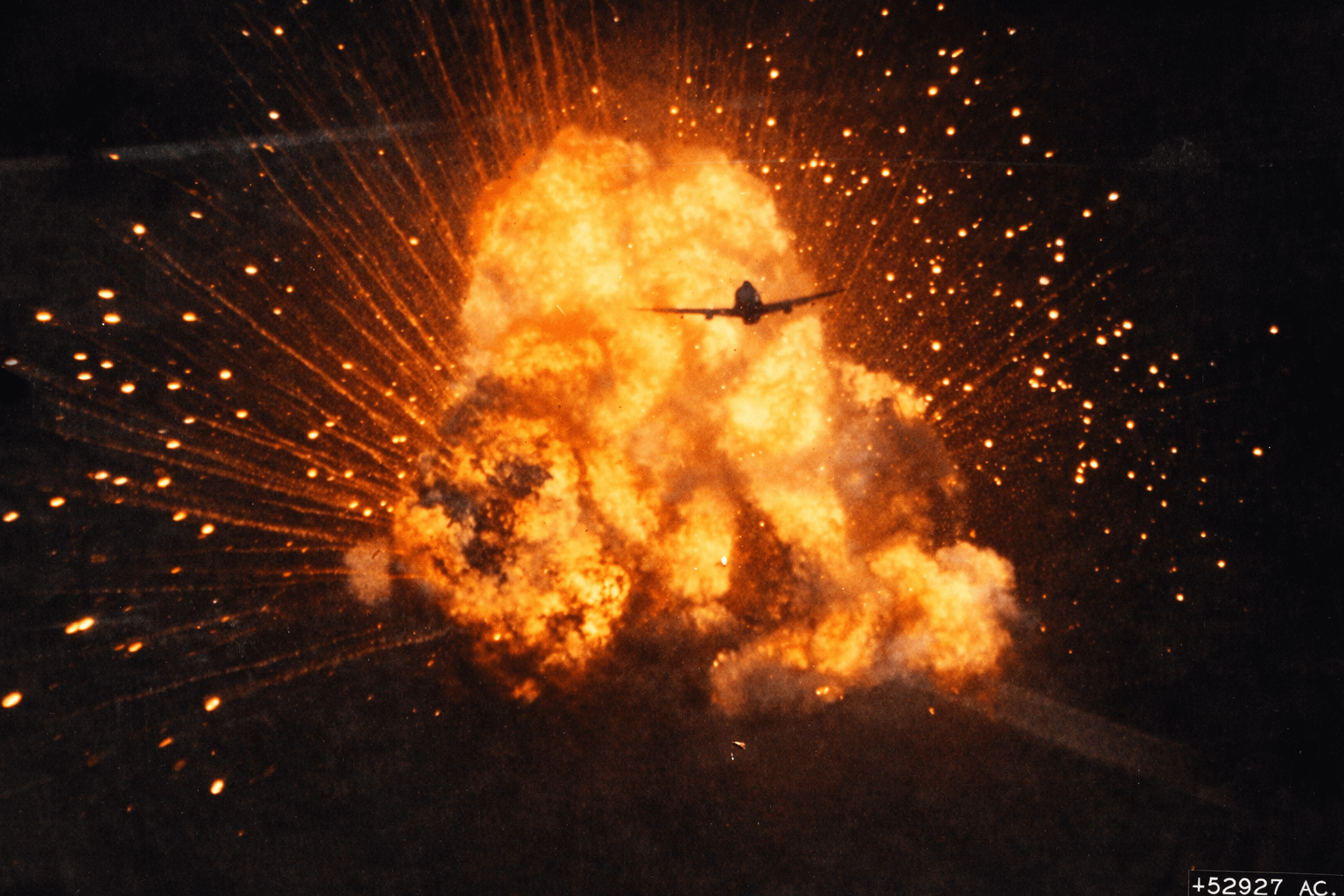 A P-47 Thunderbolt piloted by Capt Raymond M Walsh of the 406th Fighter Group is silhouetted against the exploding ammunition truck he just strafed, France, June 23, 1944. The image was captured by his wingman’s gun camera in the following P-47. [1500×1014]  – COLORIZED
