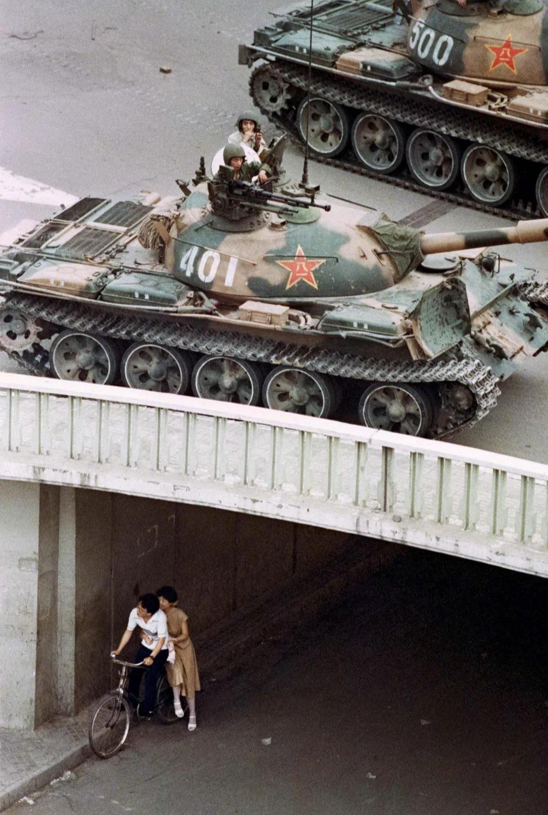 A couple takes cover under a bridge during the Tiananmen Square Massacre (June 4, 1989] [Image Resolution: 1080×1606]