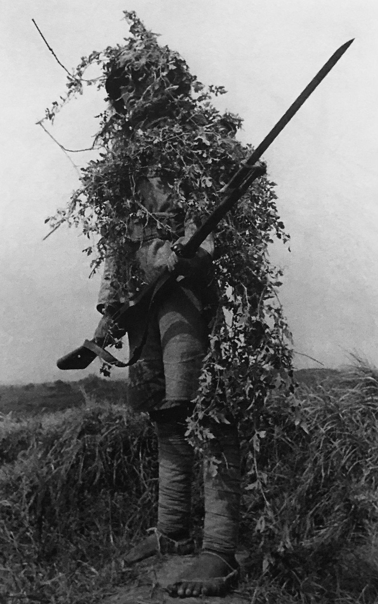 Camouflaged Chinese solder with an Arisaka Type 38 bolt-action rifle with a bayonet, in China, during the Second Sino-Japanese War, c. 1940 – 1943. [1282 x 2048]