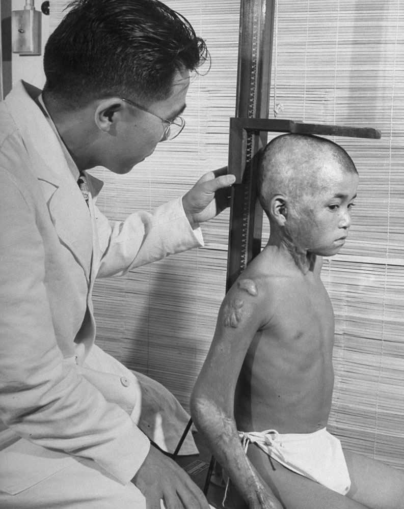 Doctor checks on a Hiroshima bombing survivor, 2 years after. Hiroshima, Japan, 1947[793×1000]