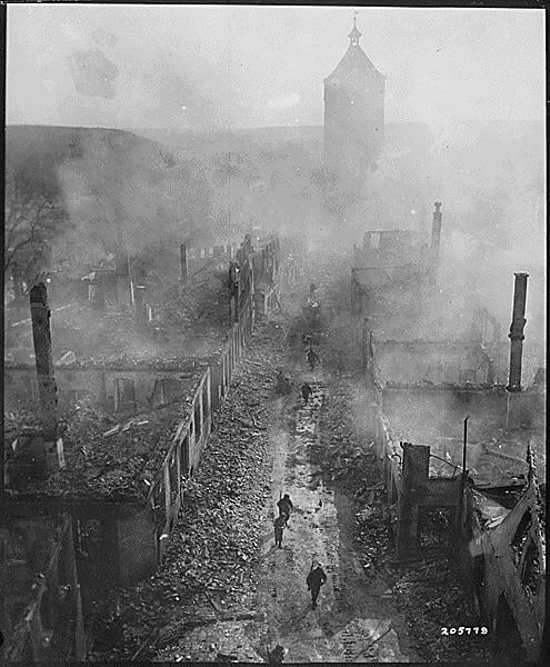 GIs of the 255th Infantry Regiment move down a street in Waldenburg after a recent raid by the 63rd Division, April 16, 1945. [495×600]