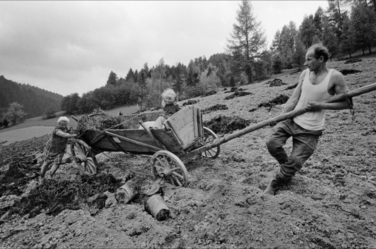 Farmer’s family from Wierchomla Wielka, Poland. The woman pushing the cart is pregnant with her twelfth child. Poland, 1976. Photo by Marian Schmidt. [1439×954]
