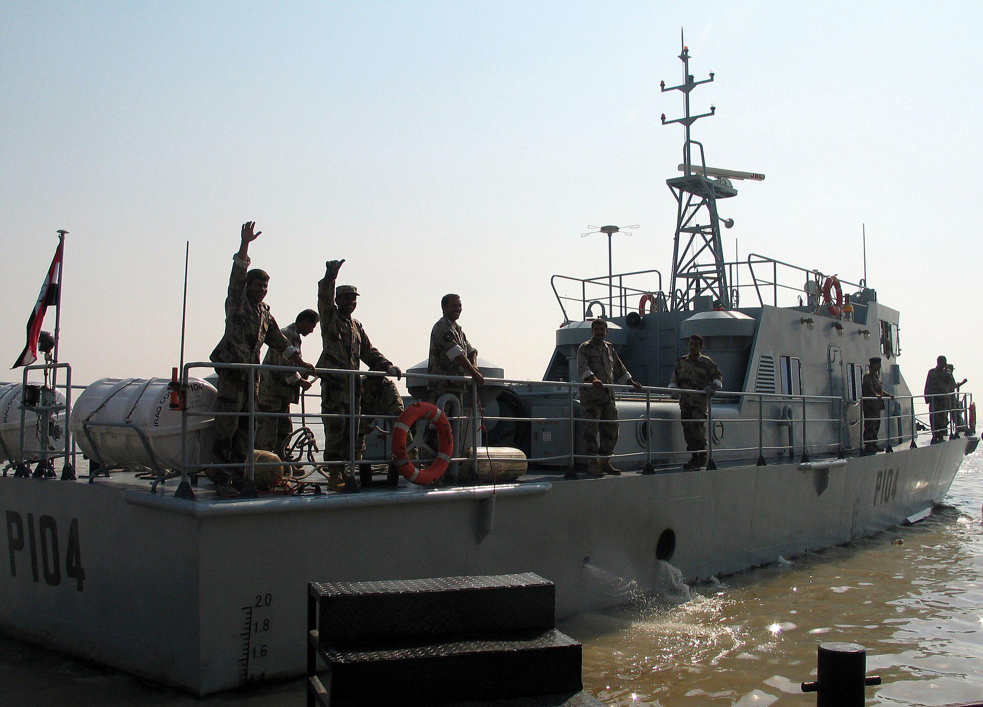 Iraqi sailors onboard the Patrol vessel (P104) assigned to the Iraqi Coastal Defense Force (ICDF) celebrate as they get underway for the first time: at the port of Umm Qasr, Iraq, on September 30th, 2004. [1920 x 1382]