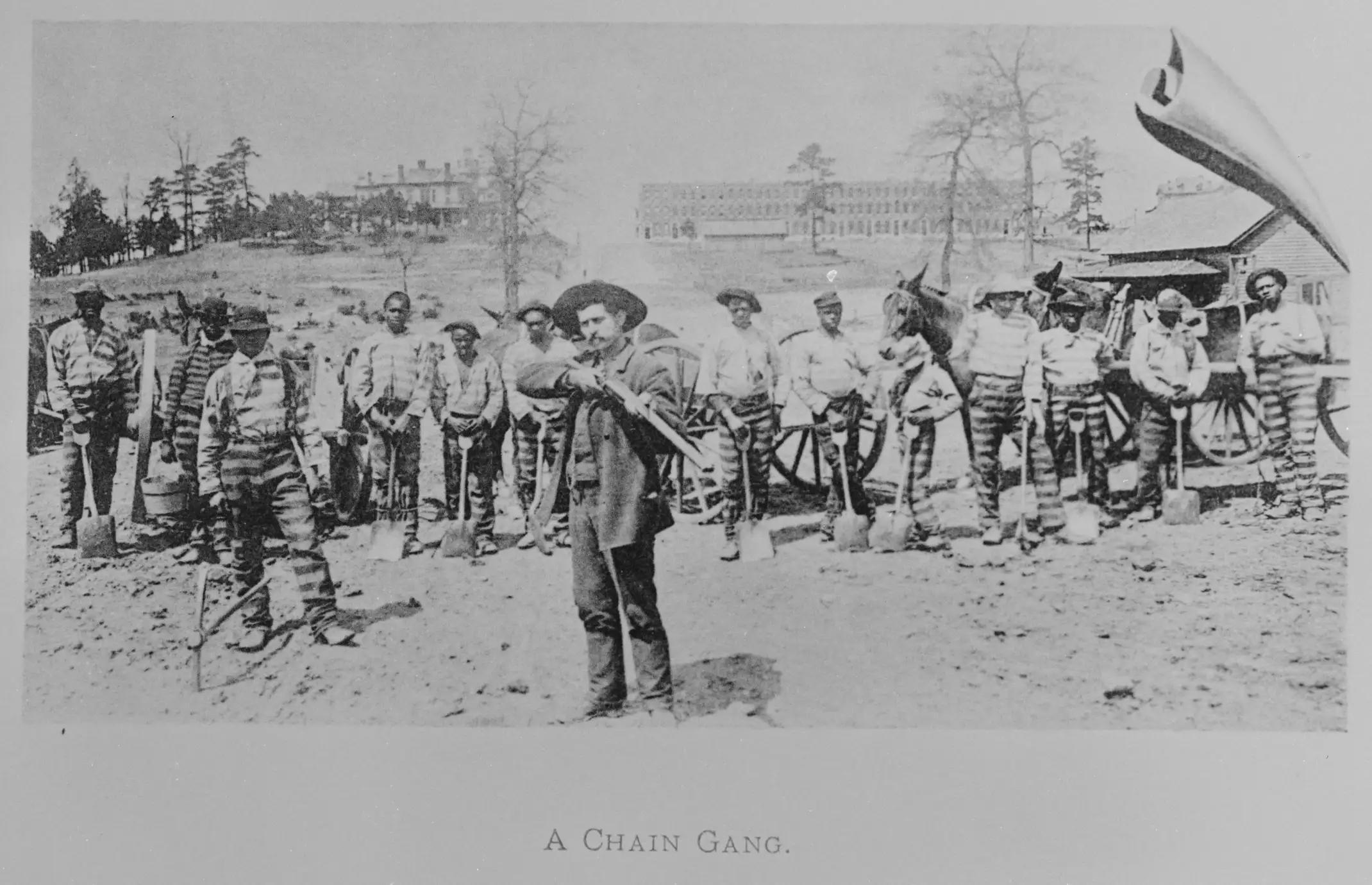 Atlanta, Georgia.  1895.  A chain gang and armed guard pose for a photo.  [2140 x 1380]