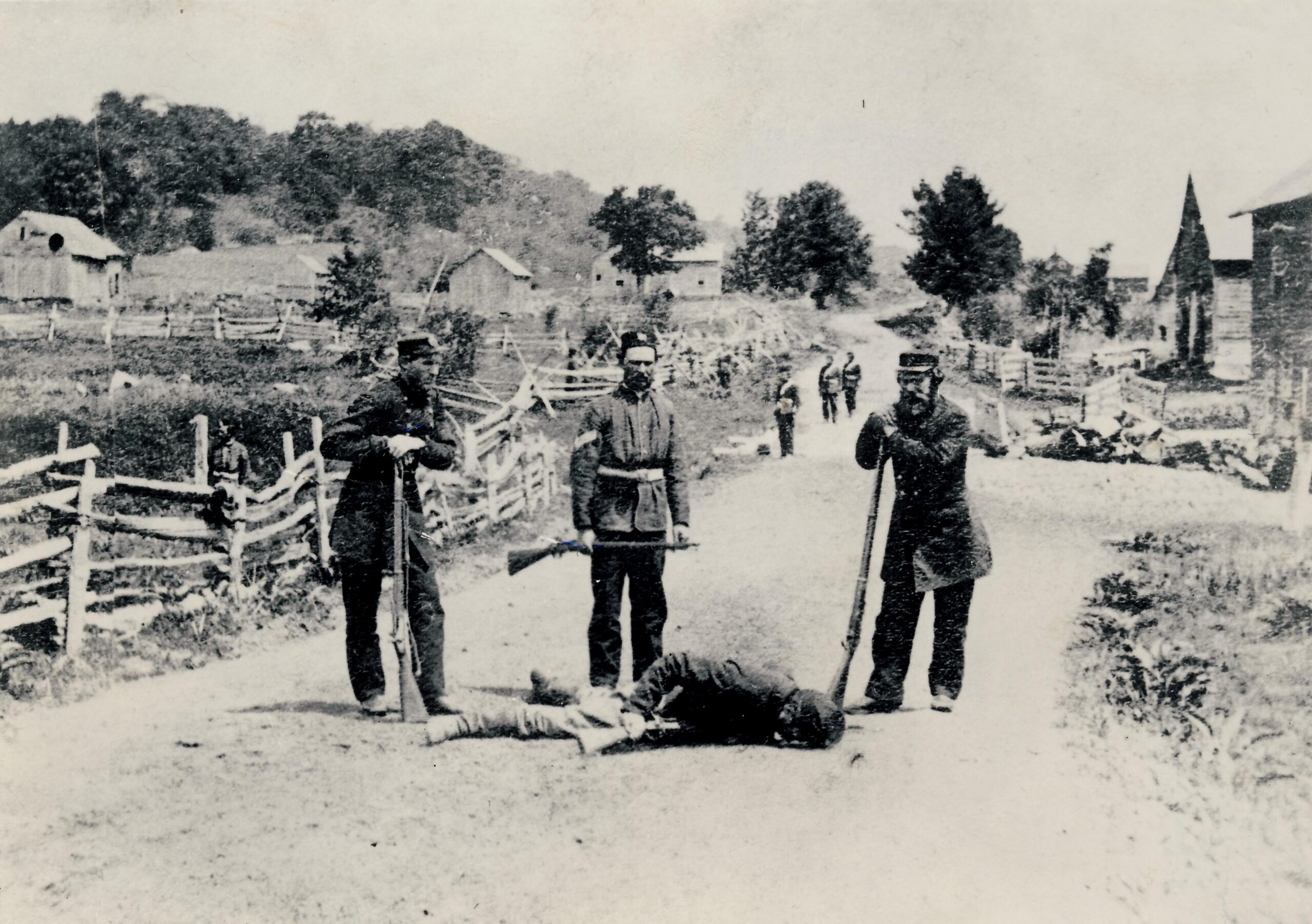 Canadian Border Volunteers stand over the body of Fenian Brotherhood fighter John Rowe after the Battle of Eccles Hill, 1870. (Missisquoi Historical Society Collections). 25th of May, 1870. [3695 × 2603]