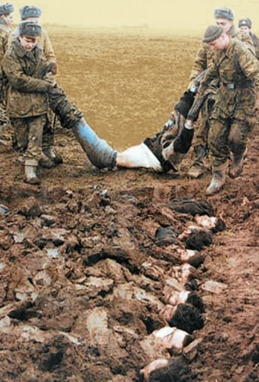 Russian troops drag a dead Chechen man to a mass grave, photographed during the second brutal invasion which killed tens of thousands of civilians. Russian-occupied Chechnya, early 2000s. [510×751]