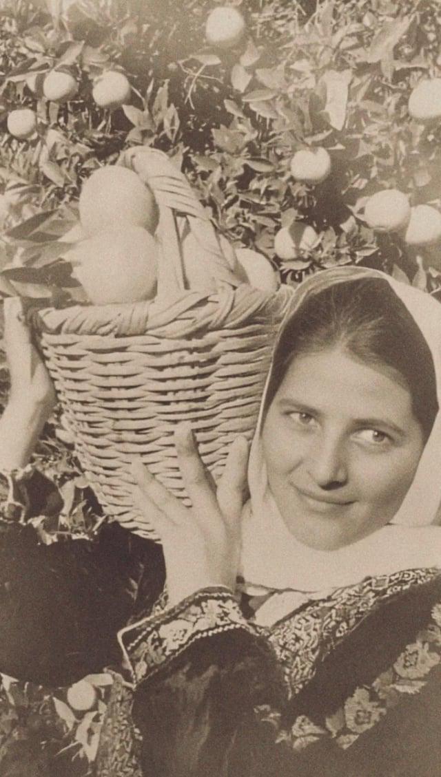 Palestinian woman from Jaffa holding a basket of oranges, 1937. [550×960]
