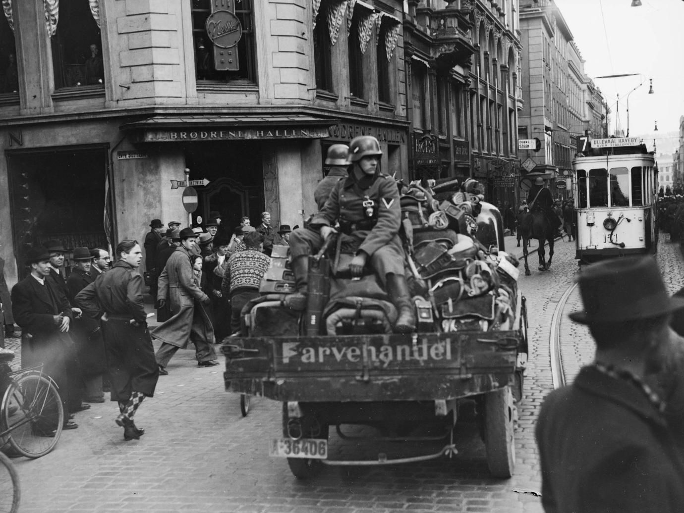 German Wehrmacht soldiers on a truck loaded with gear driving past bystanders in Oslo, Norway, during the early days of the German invasion and occupation of the country, known as Operation Weserübung. (1940) [1380×1036]