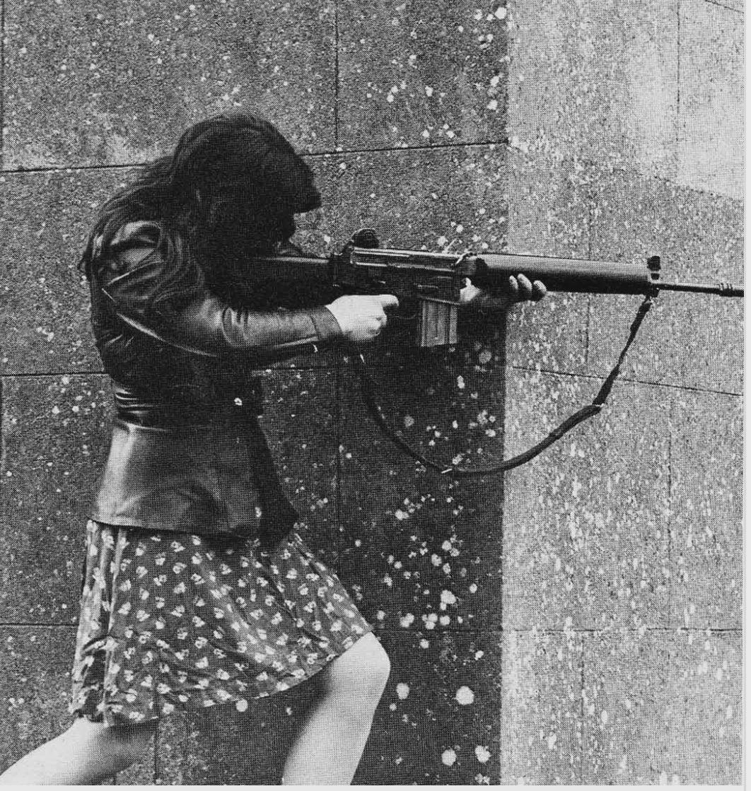 A woman IRA volunteer on active service in West Belfast with an AR18 assault rifle. Ready to engage with British soldiers, 1973. [1062×1119]