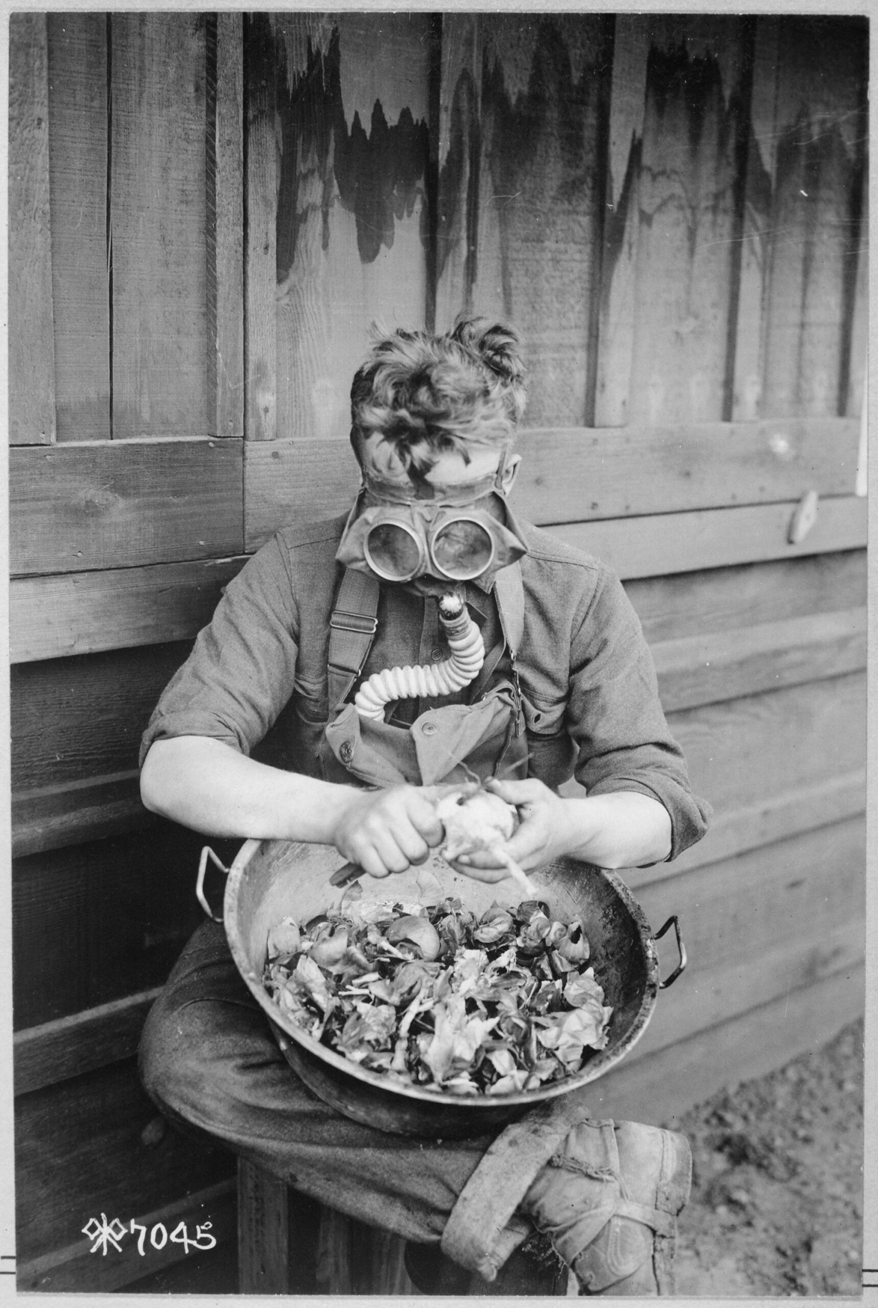 An American soldier utilizes his gas mask to peel onions, San Diego, California. 1918. [2015×3000]